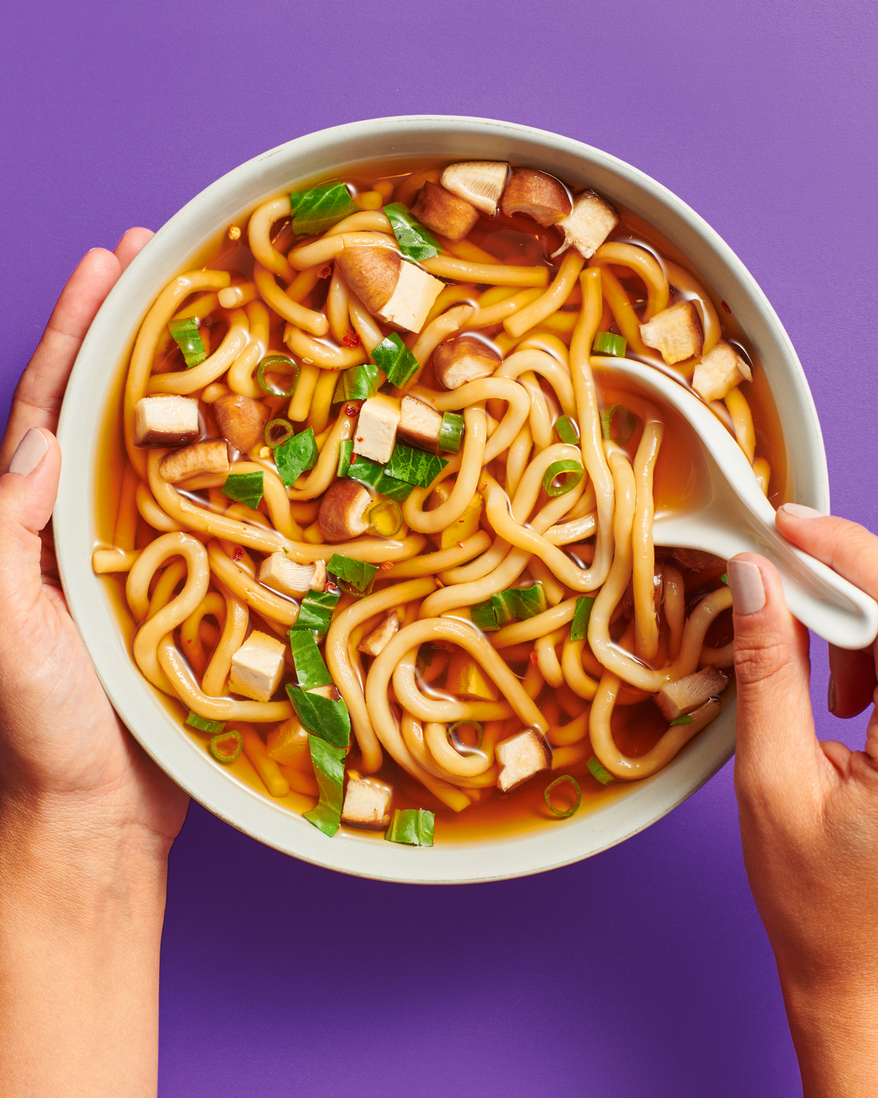 Annie Chuns noodle bowl with hands product photography.